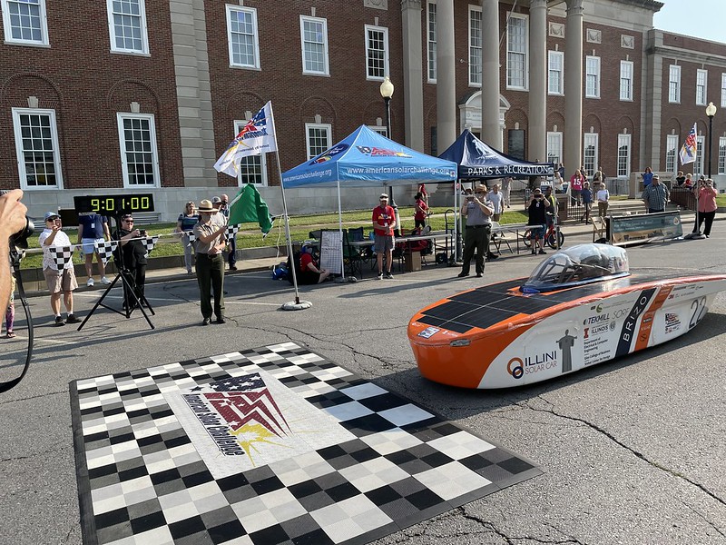 Solar Car Crossing the Start Line Timed by a National Park Service Ranger. 