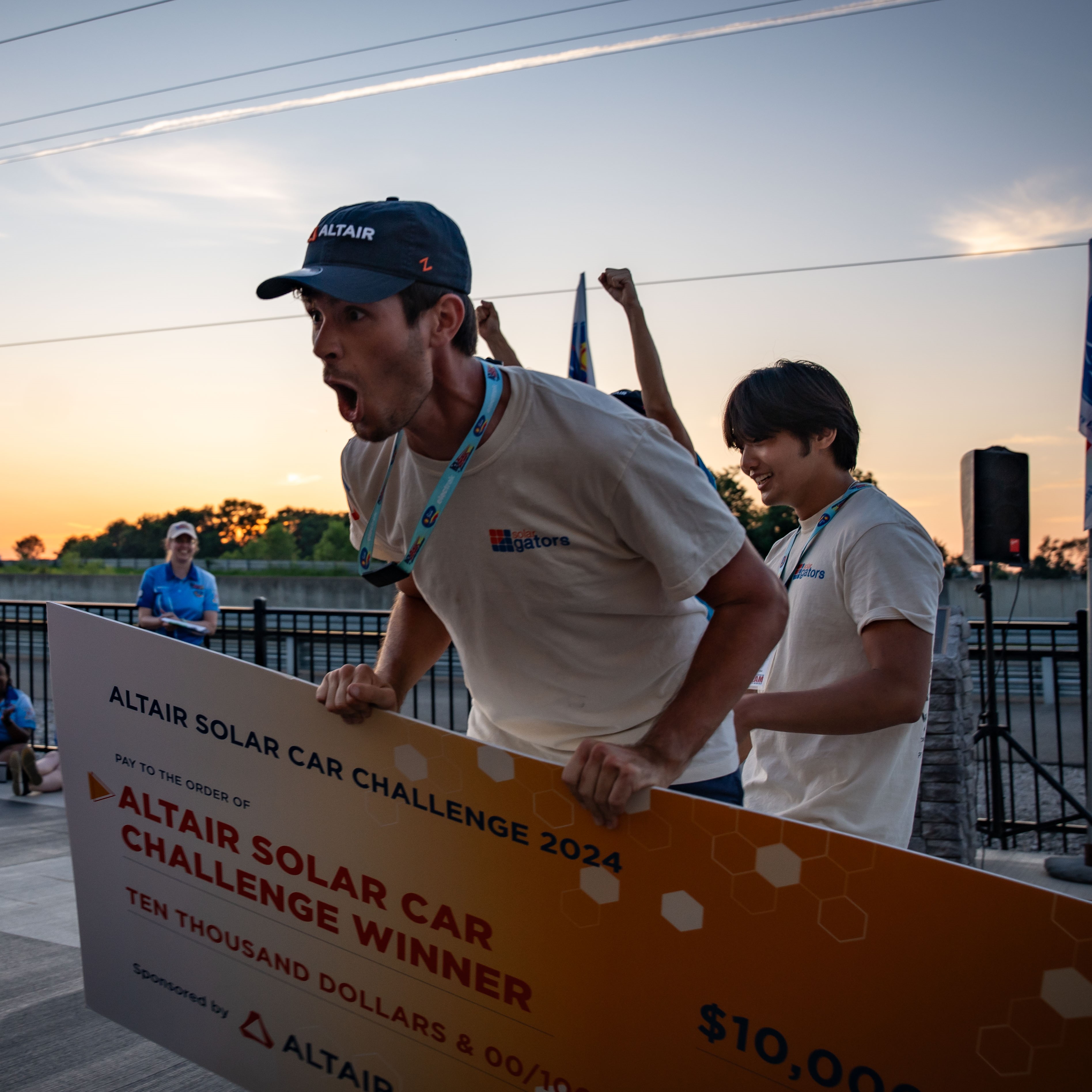 Florida Team member celebrating winning the Altair challenge holding large $10,000 check